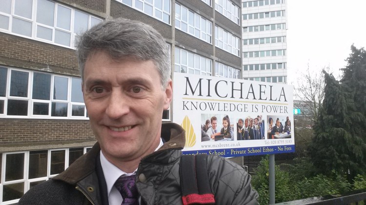 Sign for Michaela with some old bloke stood in front of it